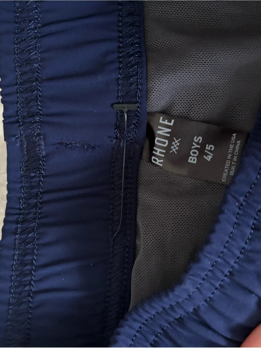 RHONE Navy Blue Kids Swim Trunks with Red Side Panel